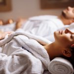 Young couple receiving head massage at beauty spa