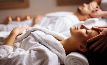 Young couple receiving head massage at beauty spa